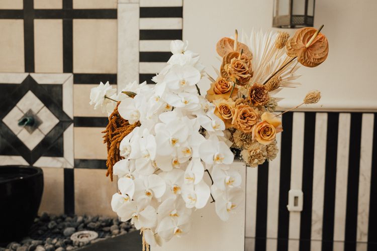 Modern graphic ceremony backdrop with orchids